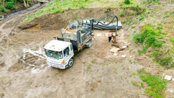  HydroMaster 2000 creating pile holes for a house foundation.