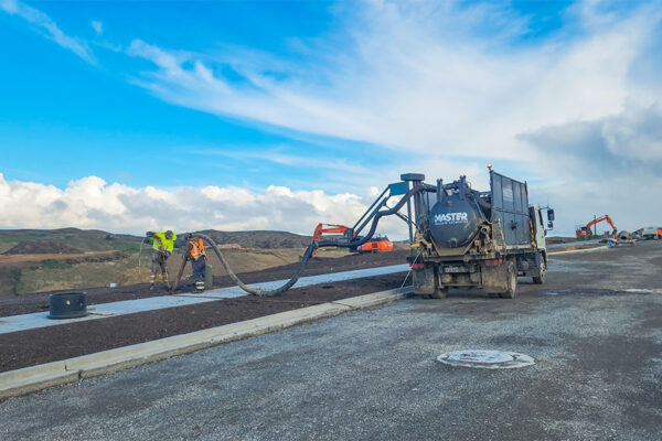 Workers using Hydro Master 2000 pump outside