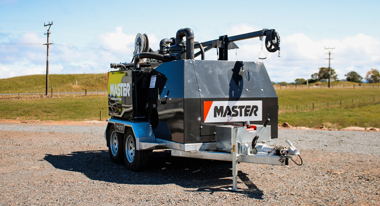 The AquaMaster 2000 cleaning out culverts under a railway line with a drain cleaning nozzle